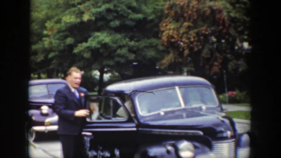 The final frame shows a suited man beside the open door of the black sedan in the 1939 Wyoming outdoor scene.