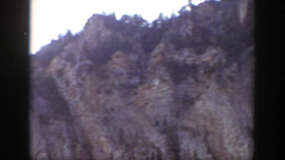 The final frame shows a steep rocky slope and bright sky, continuing the Wyoming mountain landscape view.