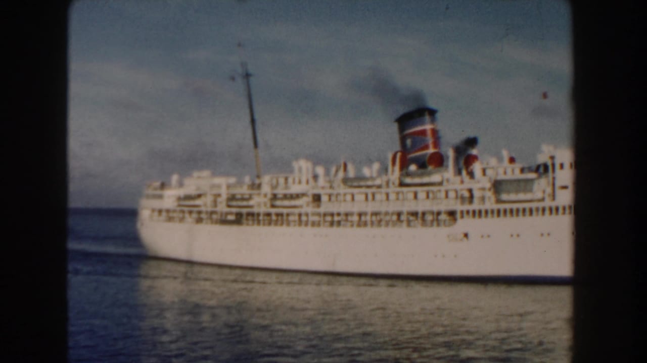 White passenger ship near the right side of the frame on open water.