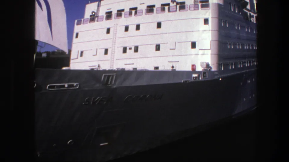 1975 Sweden 8mm view of the docked Svea Corona, showing the hull name, white side wall, and stacked passenger decks.