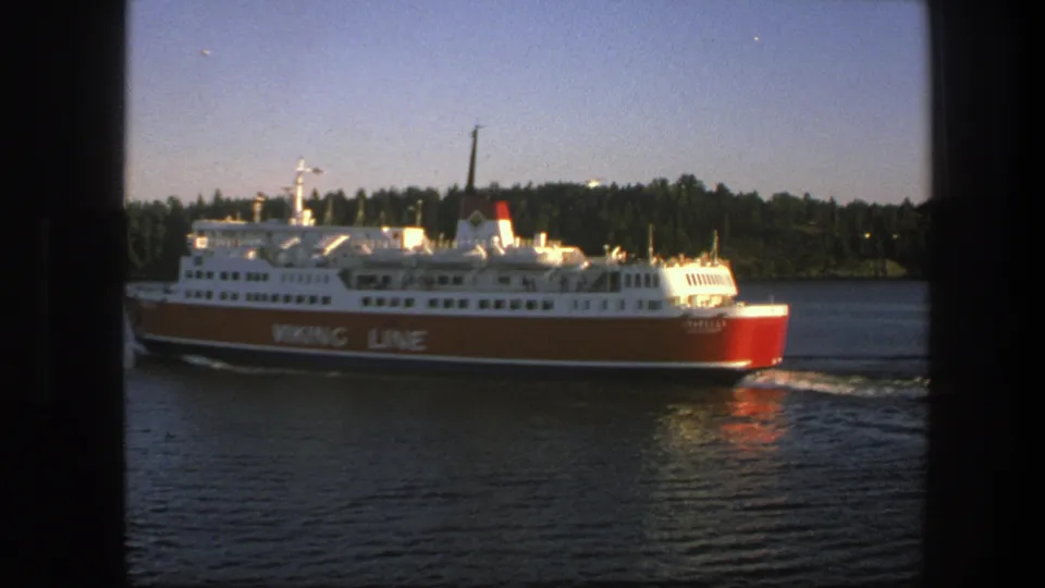 The Viking Line ferry continues across calm Swedish waters, with its branded red hull and white decks visible.