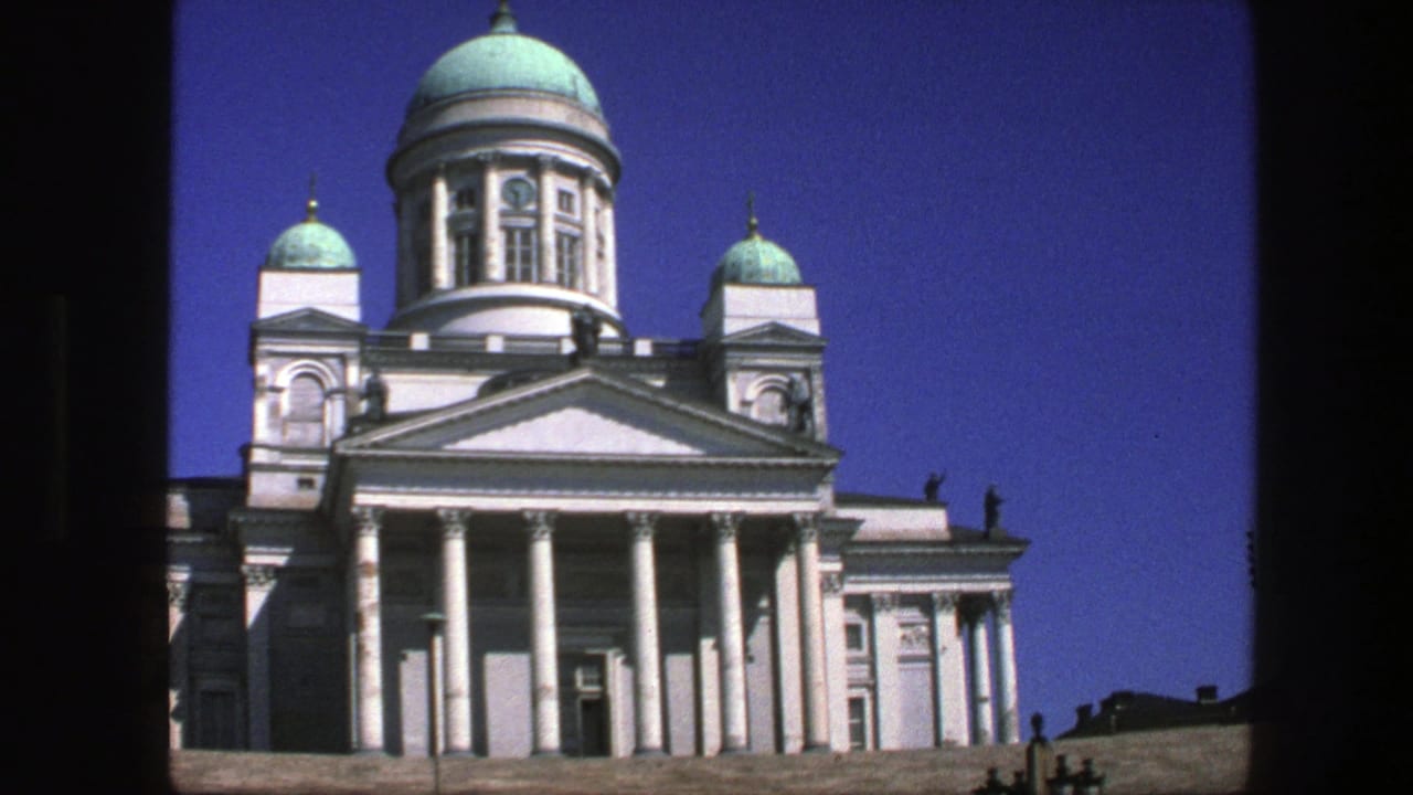 Cataloged 1975 Nordic travel footage showing a white columned building with turquoise domes against blue sky.