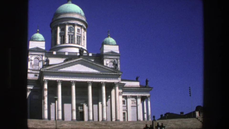 A white neoclassical facade with turquoise domes fills the 8mm frame, cataloged as Sweden in 1975.
