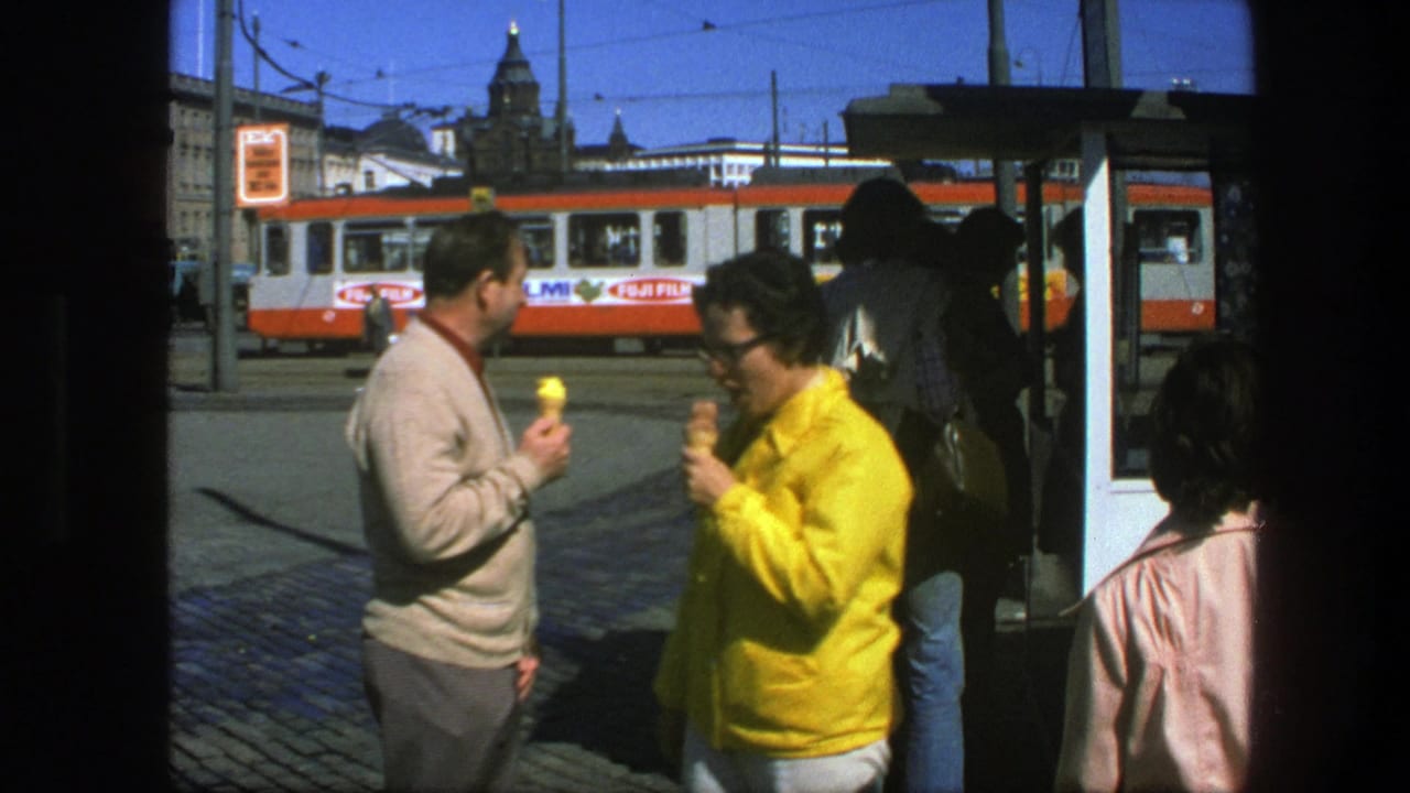 Adults eating ice cream at a tram stop with a red-and-white tram behind them.