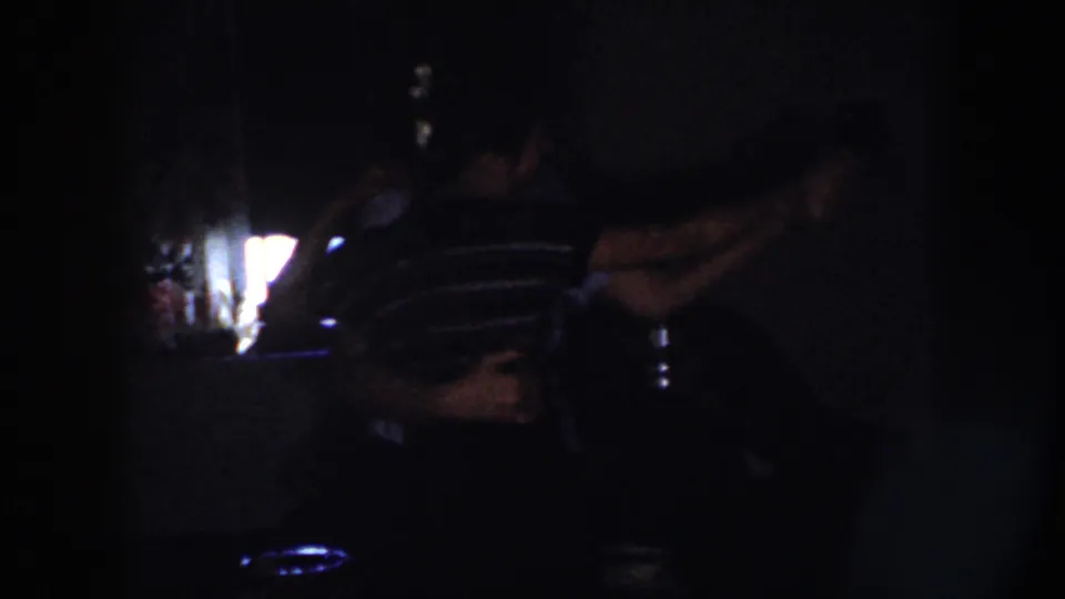In Nebraska 1958 home-movie footage, a couple appears to dance in a dark room beside the glow of a television screen.
