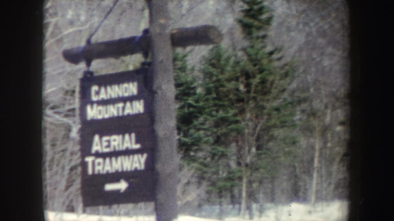 Cannon Mountain Aerial Tramway sign framed by winter trees.