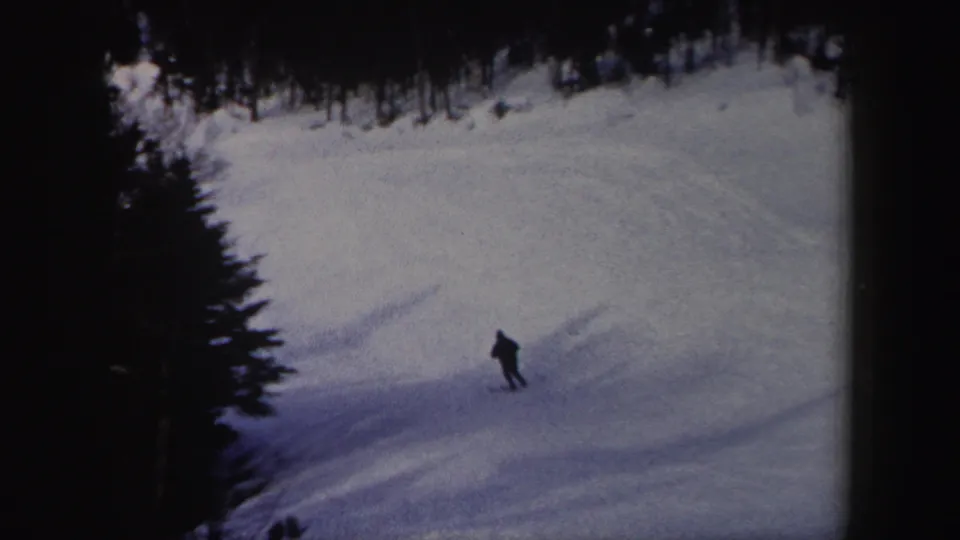 Near the end of the clip, the skier appears small against the snowy New York hillside and dark tree border.