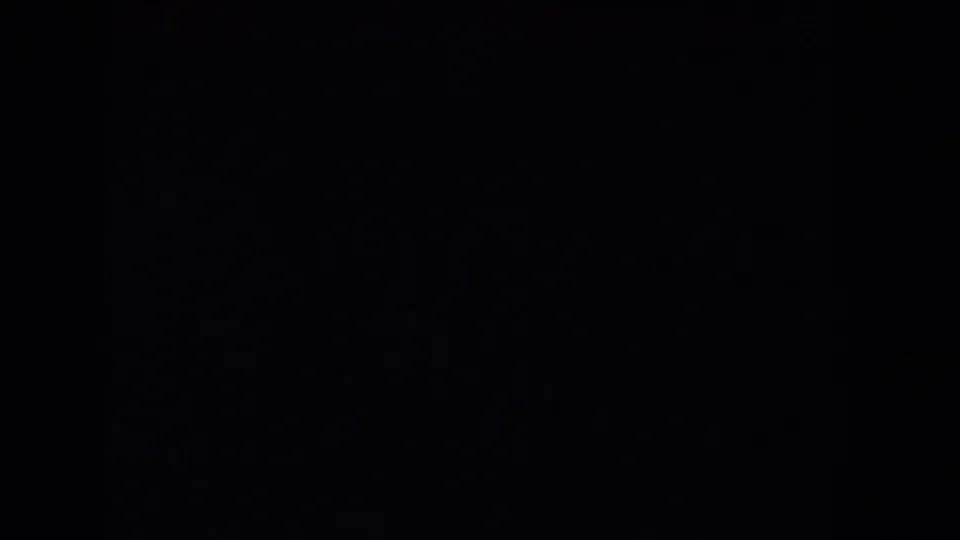 Mostly black 8mm frame from the 1962 Glendale clip with faint blue-green density and visible grain.