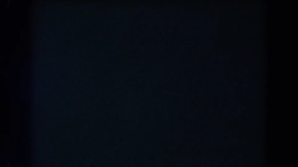 Dark 1962 8mm home-movie frame from Glendale metadata, showing only faint blue-black exposure and film texture.
