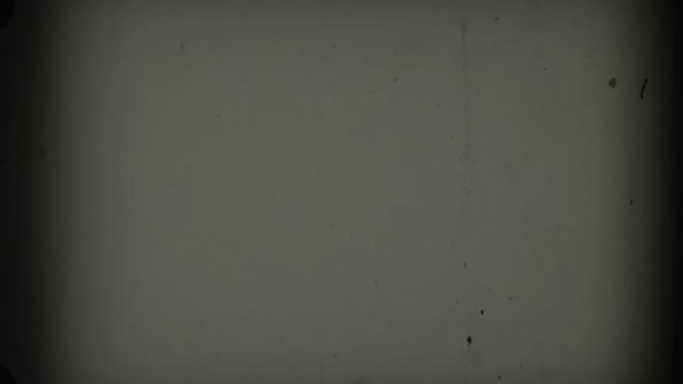 1962 Glendale 8mm frame showing a mostly blank gray field with film grain, specks, and dark gate shadows.