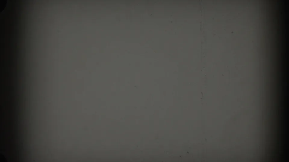 Blank 8mm frame from the Glendale reel with gray exposure, scattered dust, and a strong dark vertical edge shadow.