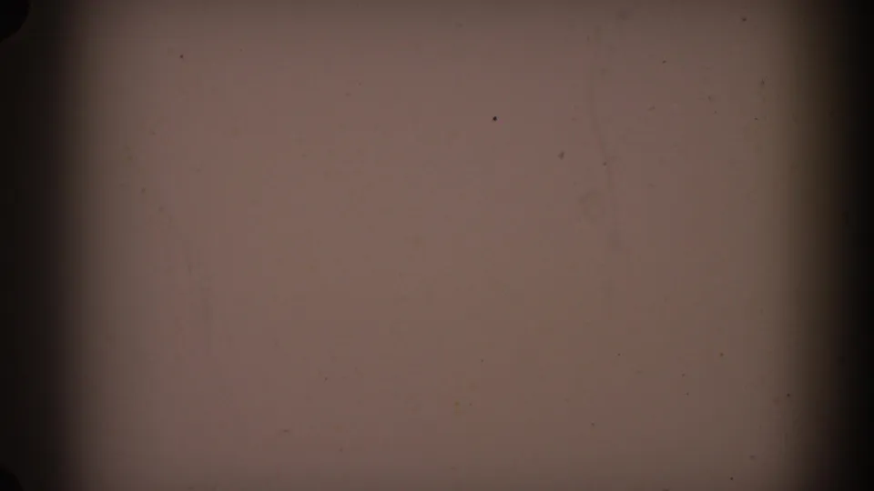 1962 Glendale 8mm frame showing an abstract brown-gray film surface with dark vertical bands, dust, grain, and minor scratches.