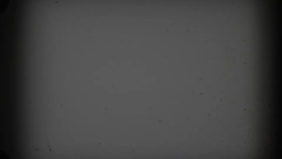 Dim 1962 Glendale 8mm frame with muted gray-green exposure, dust, grain, and black gate edges before the subject is visible.
