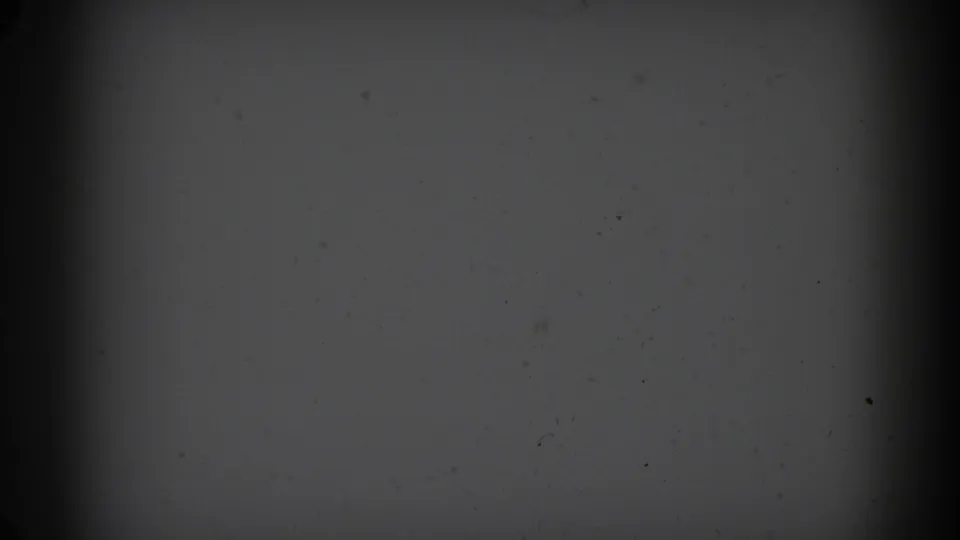 1962 Glendale 8mm frame with a gray overexposed field, central vertical shadow, dust marks, and worn film texture.