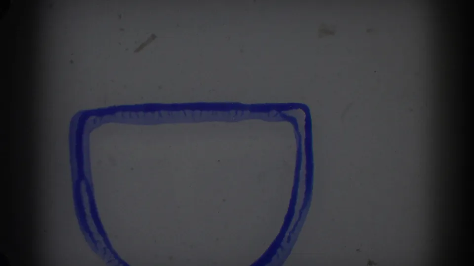 1962 Glendale 8mm frame with a blank gray field, blue outlined marking near the bottom, dust, scratches, and gate shadow.
