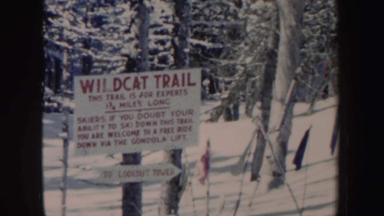 1962 New Hampshire frame with a red-letter Wildcat Trail sign warning expert skiers and pointing toward Lookout Tower.
