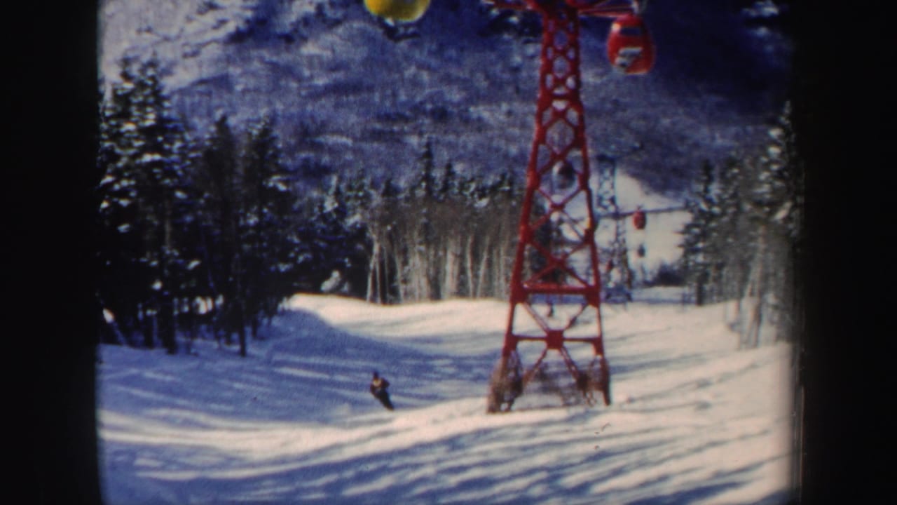 Near the end of the clip, the skier continues downhill on the New Hampshire run beneath visible lift equipment and trees.