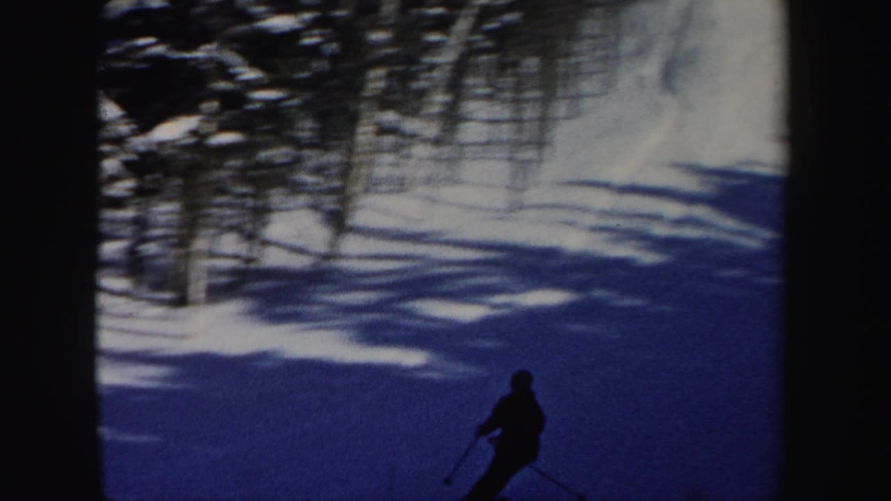 A lone skier crosses a snowy New Hampshire slope in this 1962 home-movie frame.