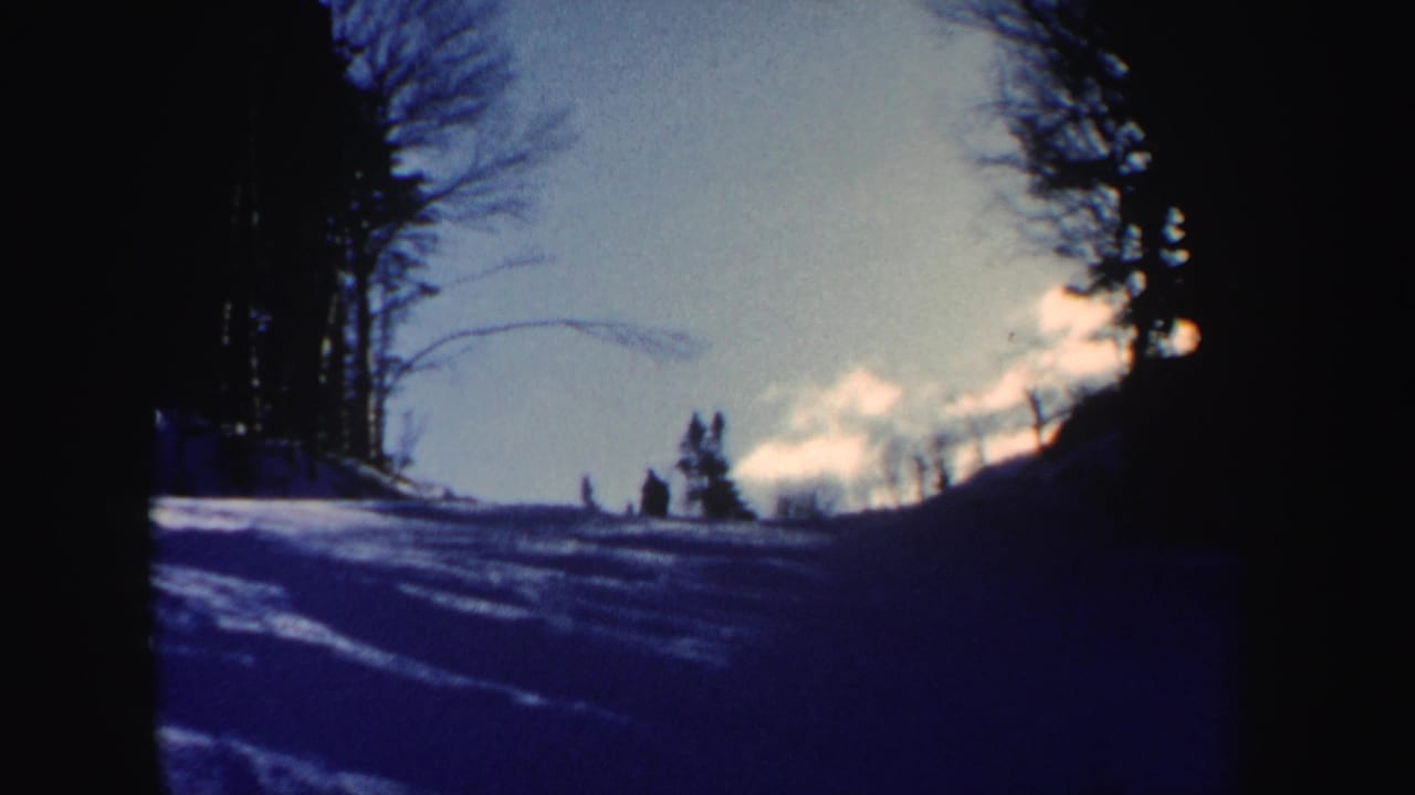 A distant skier-like figure appears on a New Hampshire snow slope in this 1962 8mm home-movie frame.