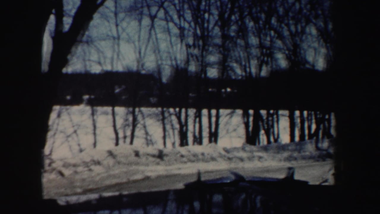 A snow-covered roadside and leafless trees appear in the same New Hampshire winter home-movie sequence.