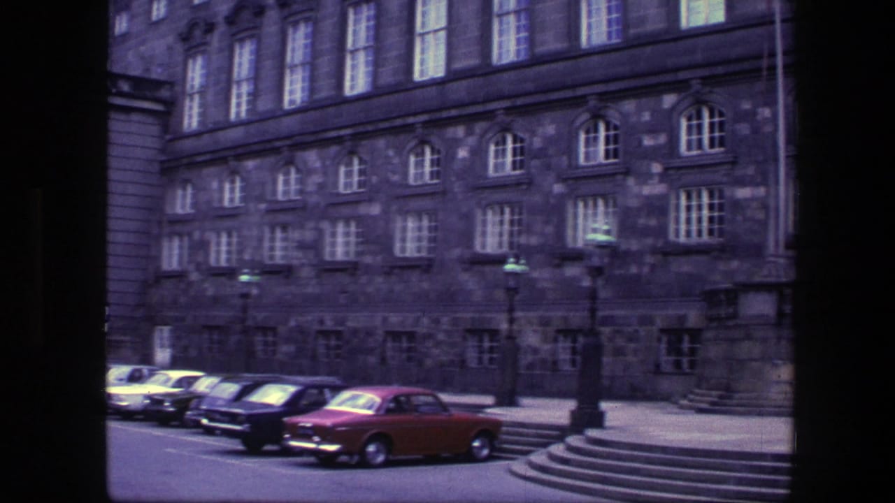 1975 Copenhagen street view of an ornate stone building, parked classic cars, and a broad staircase crossing the lower frame.