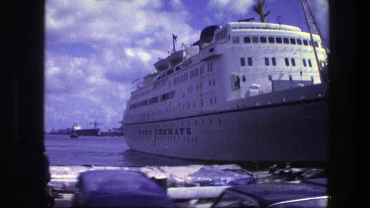 White SUN SEAWAYS ship at port with cars and harbor water in front.