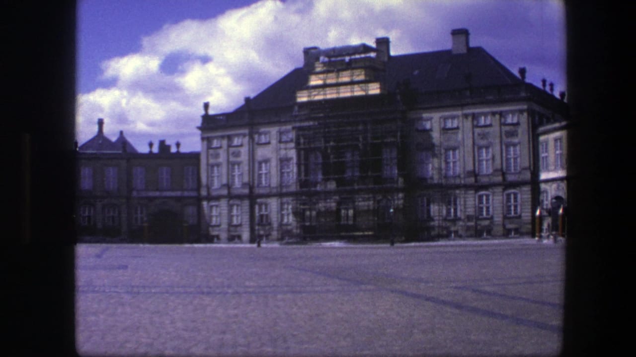 Amalienborg Palace facade with scaffolding across a broad cobblestone courtyard.