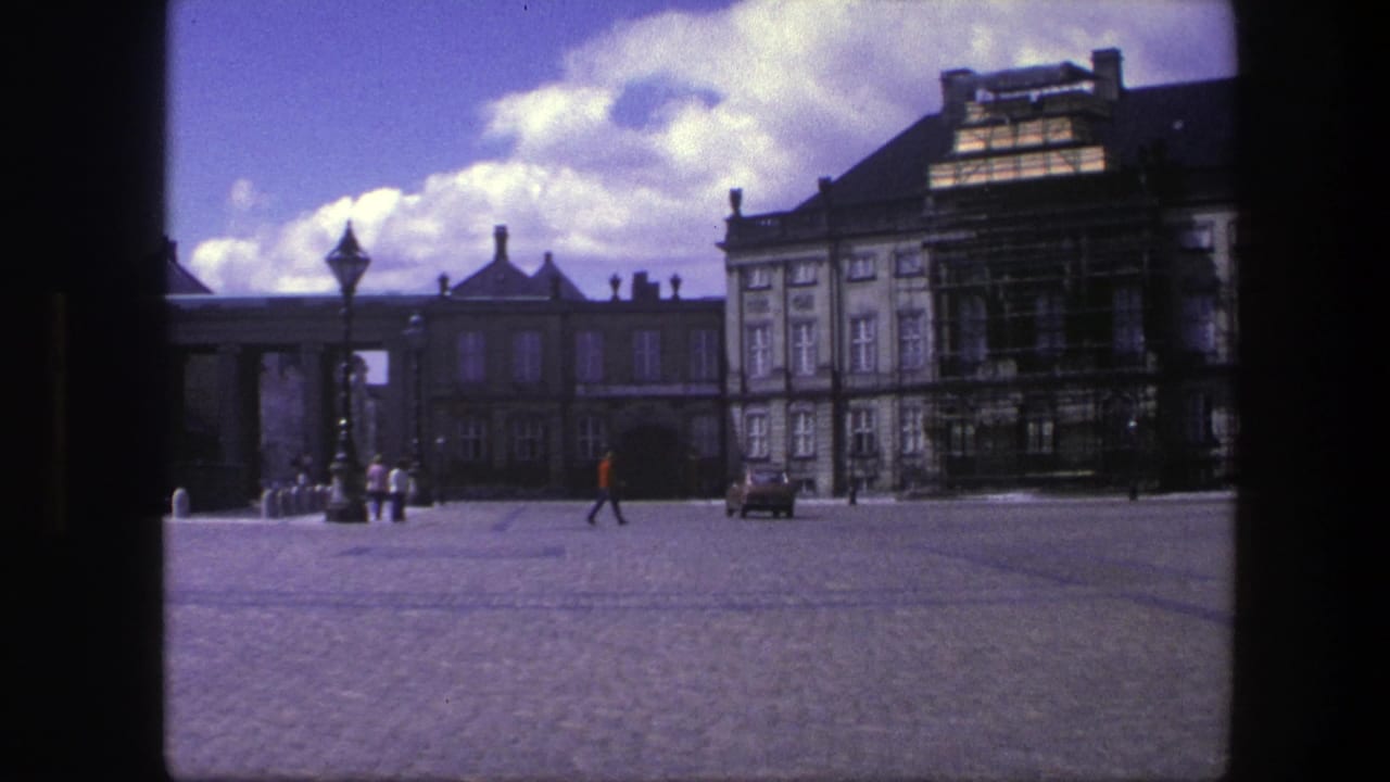 Historic square with scaffolding, pedestrians near a lamp, and a red-shirted walker crossing.