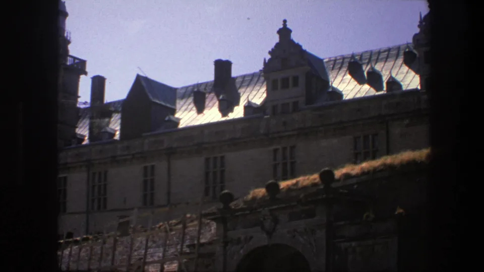 1975 Copenhagen architectural view with gabled roof, chimneys, upper windows, and a partially visible arch below.