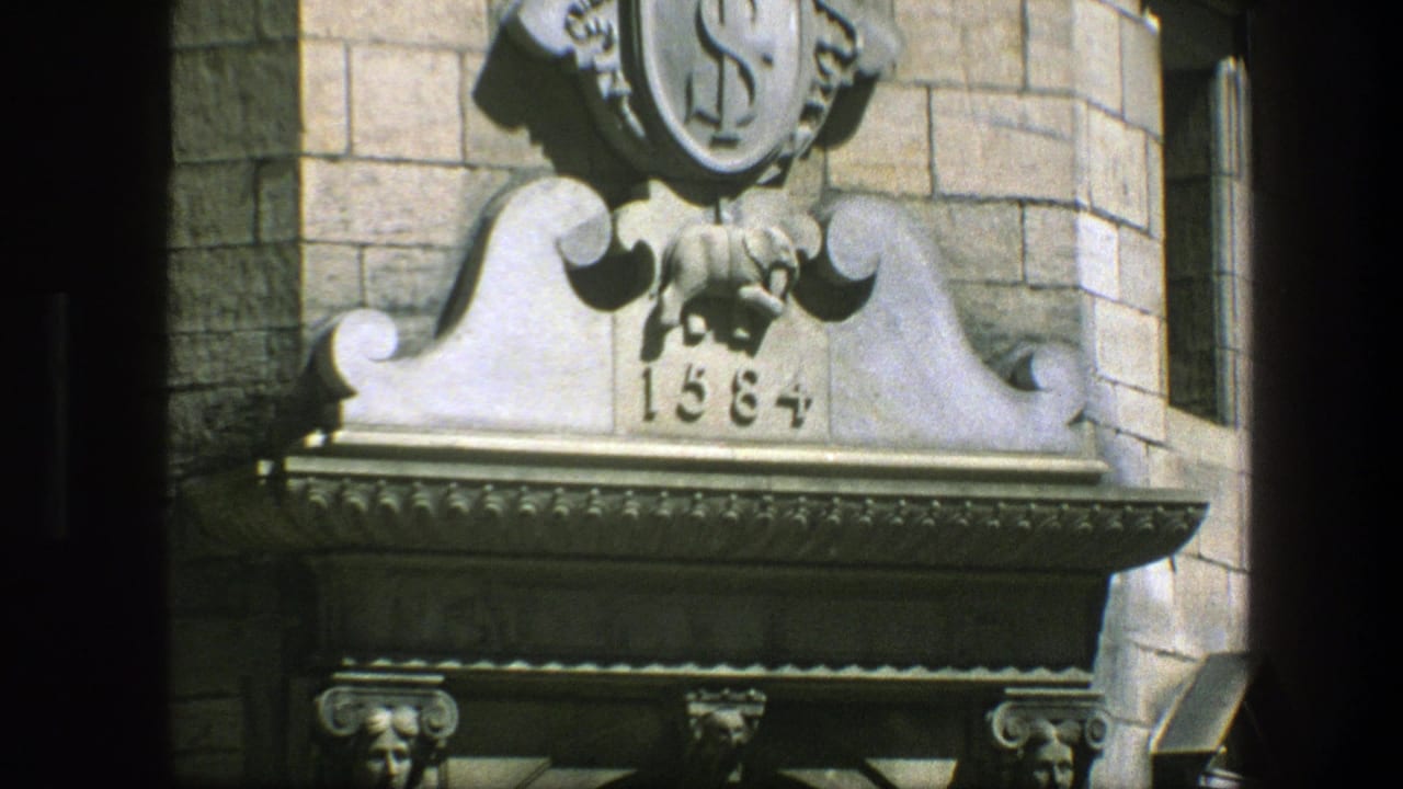 1975 Copenhagen 8mm frame showing a close view of an ornate stone doorway ornament with a shield-like emblem and date 1584.