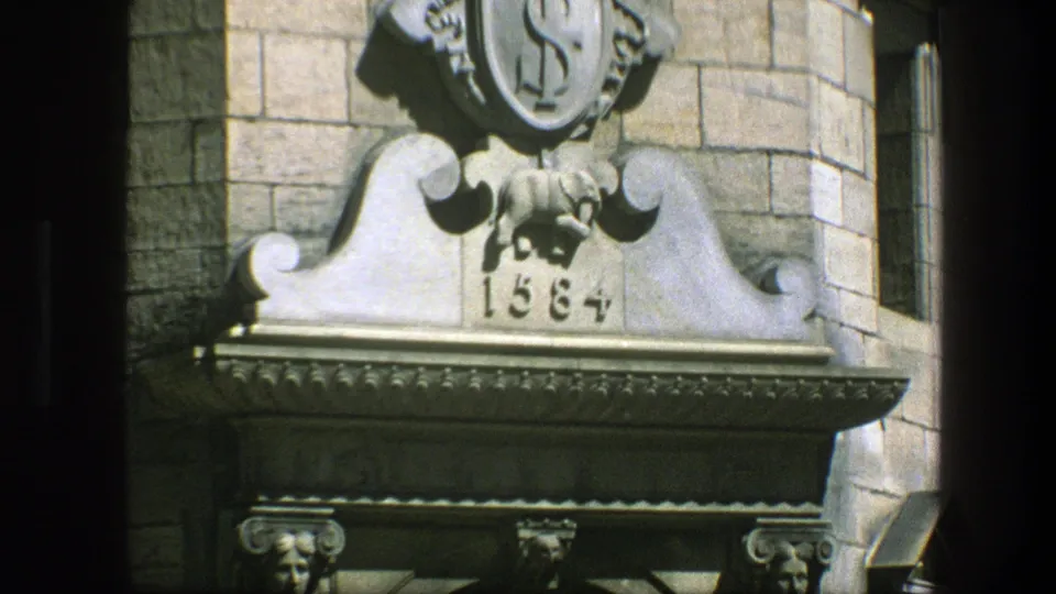 1975 Copenhagen 8mm frame showing a close view of an ornate stone doorway ornament with a shield-like emblem and date 1584.
