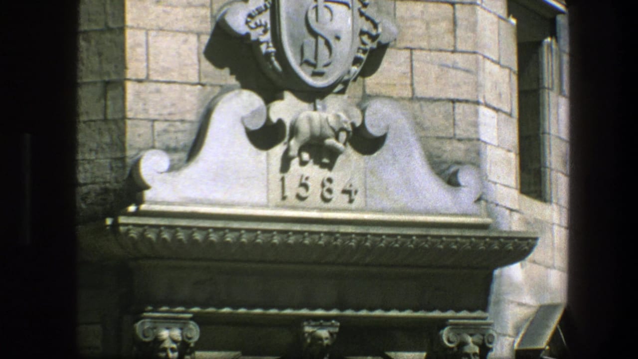Stone facade ornament above a doorway with shield, carved elephant, and 1584 date.