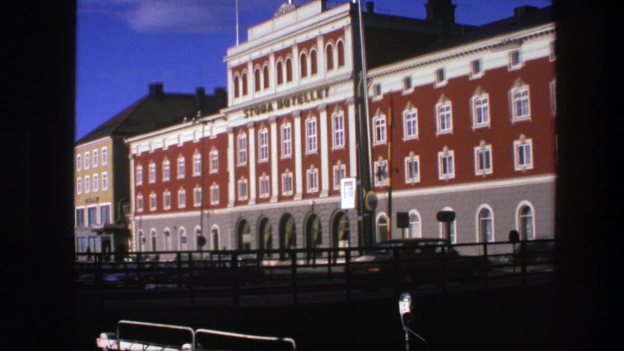 1975 Copenhagen hotel exterior with Stora Hotellet signage, red facade, white trim, and dark foreground framing.