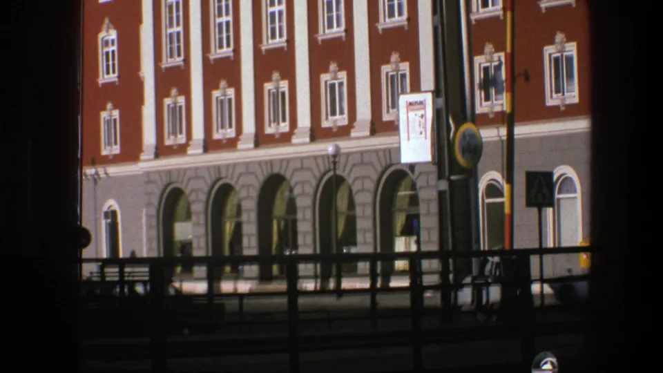 Tight 1975 Copenhagen hotel exterior showing rows of windows, arched ground-floor openings, and street railings.