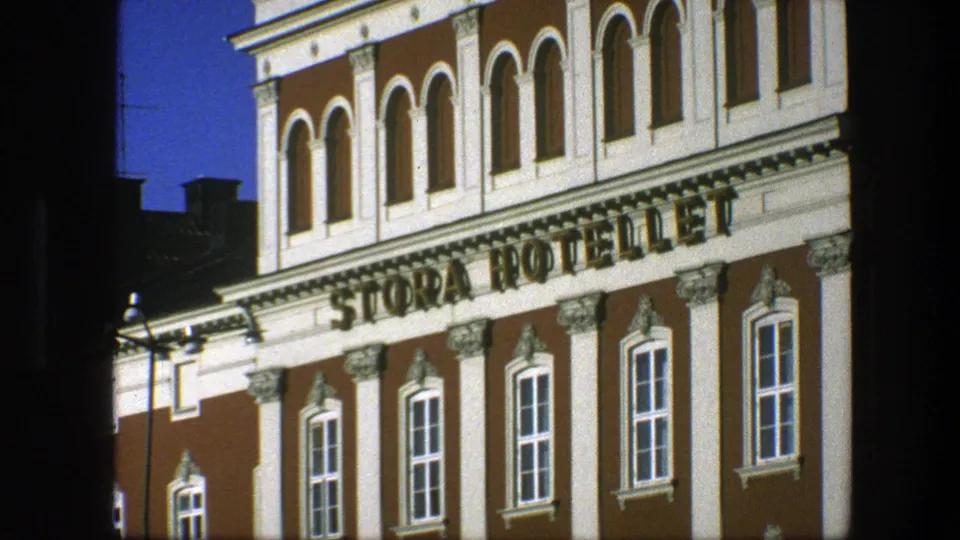 Close 1975 Copenhagen view of the STORA HOTELLET sign on an ornate red and white building facade with arched upper windows.