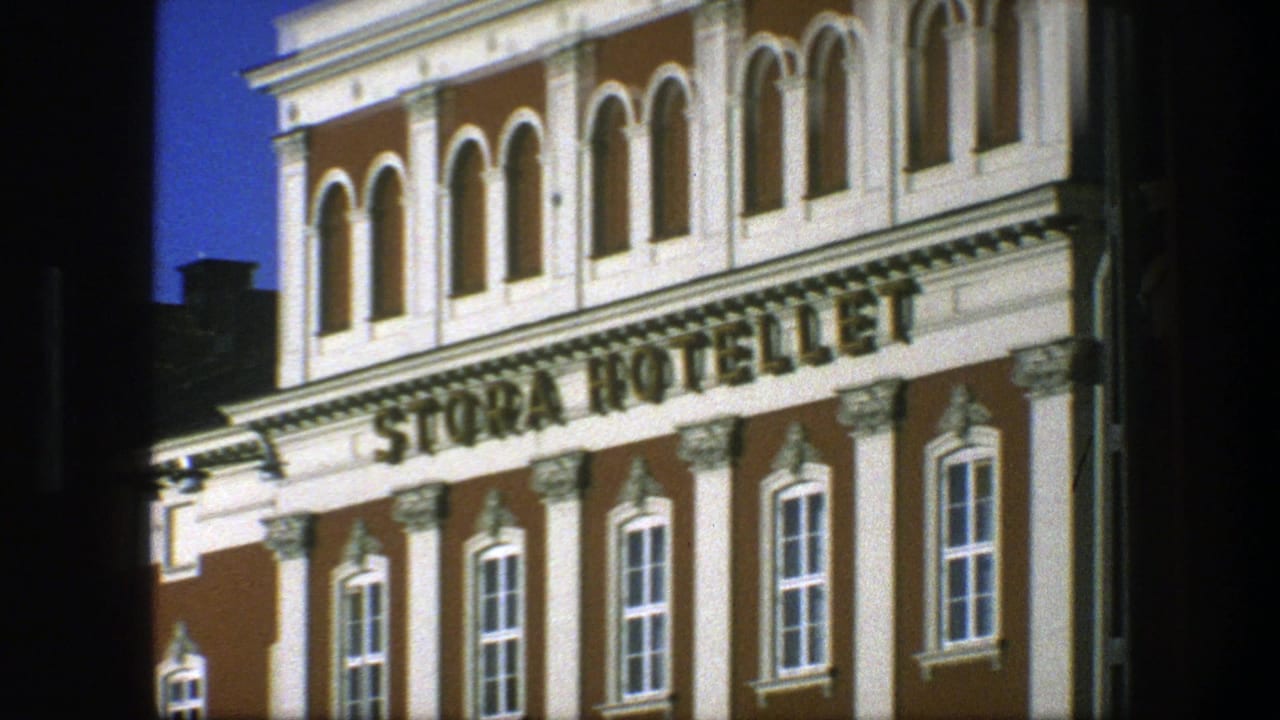 1975 Copenhagen 8mm frame showing the Stora Hotellet sign across an ornate brown-and-white facade with arched upper windows.
