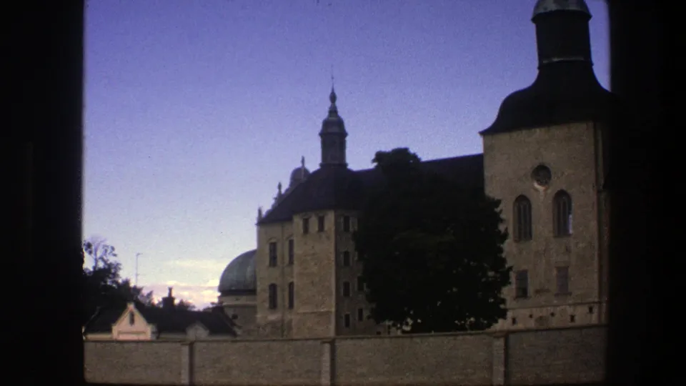 The final 1975 Copenhagen still holds on tan historic architecture, a green dome, a tree, and a clear blue sky.