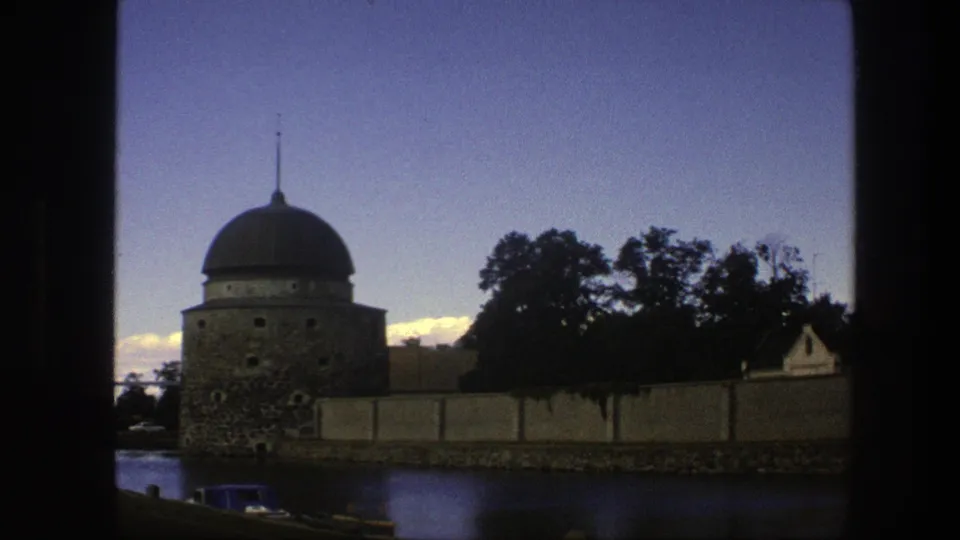 1975 Copenhagen home-movie view of the domed stone tower centered behind the wall and waterway.