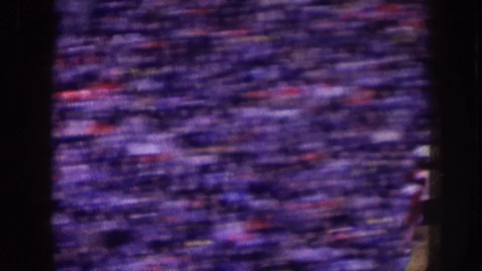 Nebraska 1957 8mm frame of densely packed spectators, blurred by fast handheld camera movement across the stands.