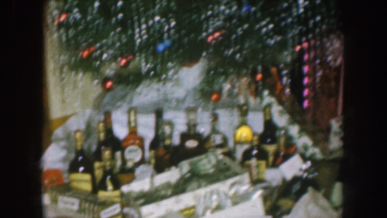Liquor bottles, ornaments, and scattered gifts under a Christmas tree.
