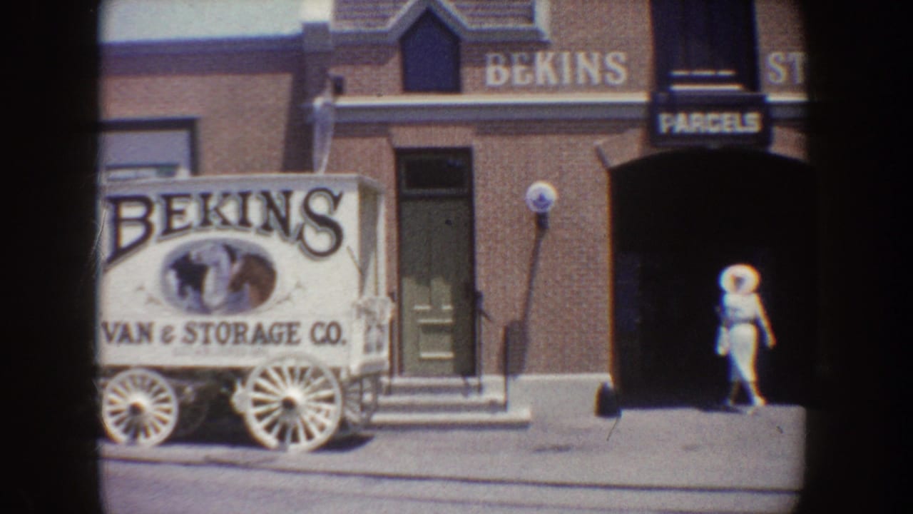 White Bekins Van & Storage Co. wagon display outside a brick facade.