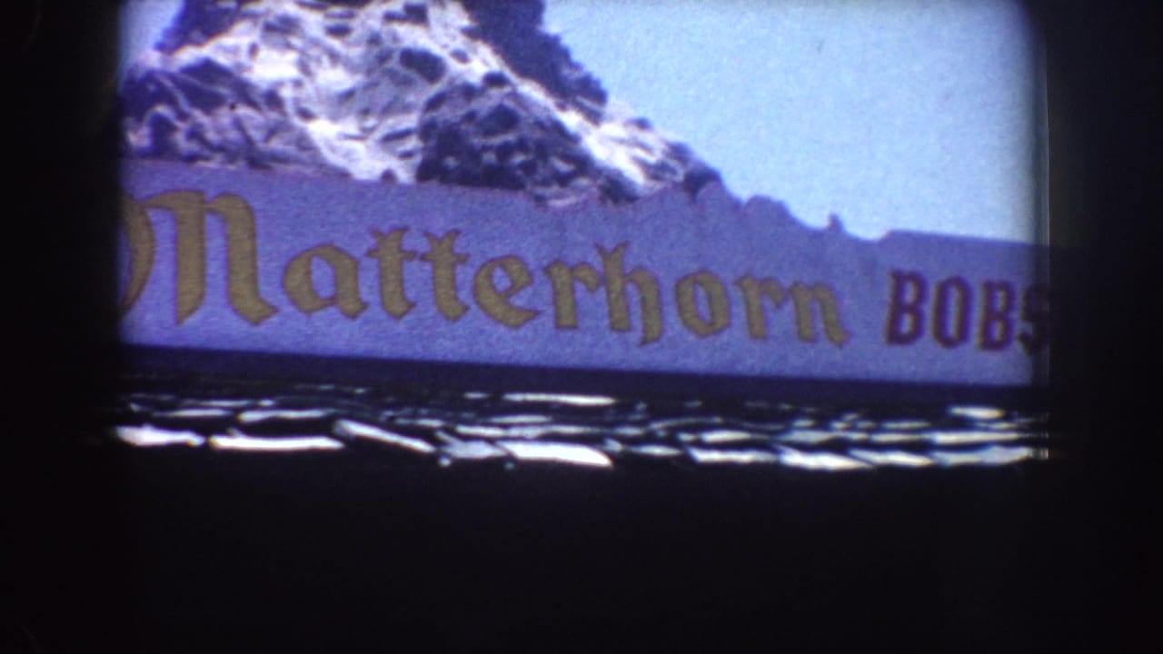 Matterhorn Bobsleds sign centered below a painted snowy peak.