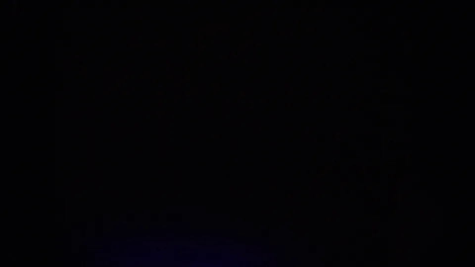 Very dark closing frame from the ride sequence, with the image mostly obscured by shadow and film edge darkness.