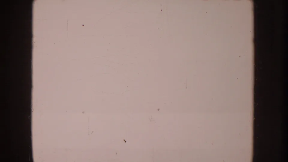 Final 8mm frame appears mostly overexposed or blank, retaining dust, scratches, faded color, and dark vertical borders.