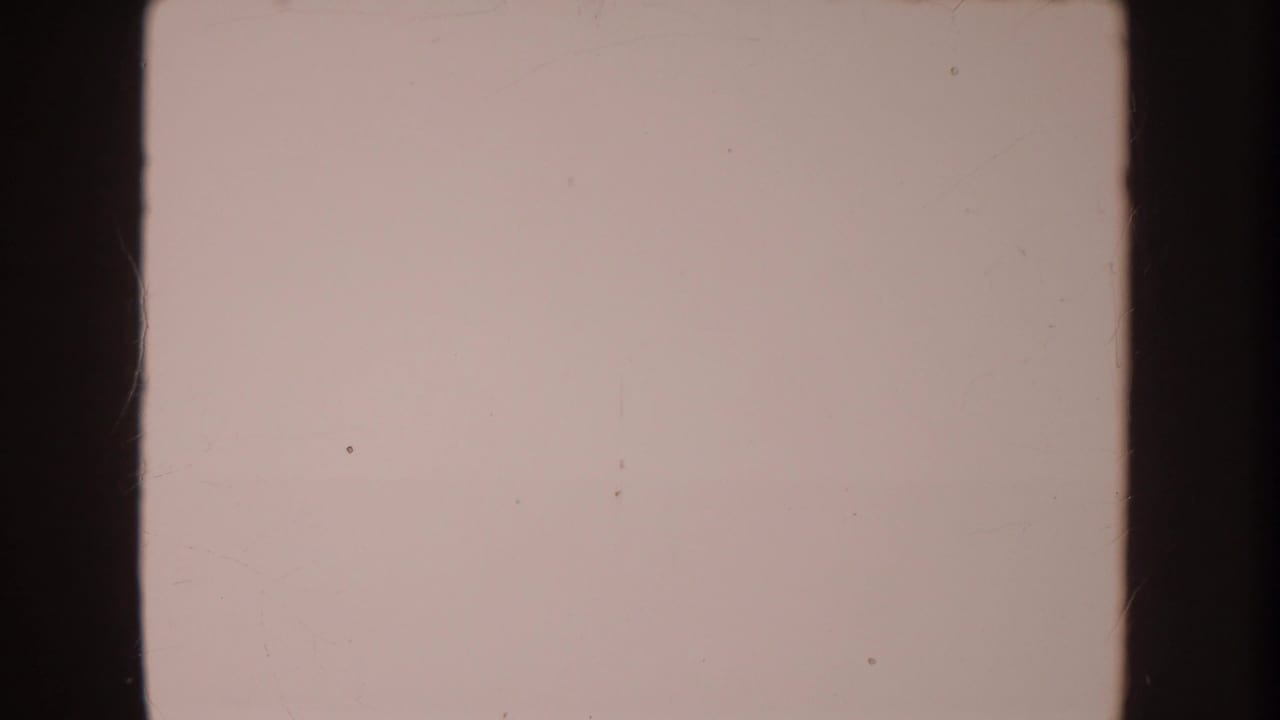 Mostly pale film frame with dark vertical borders and small dust marks.