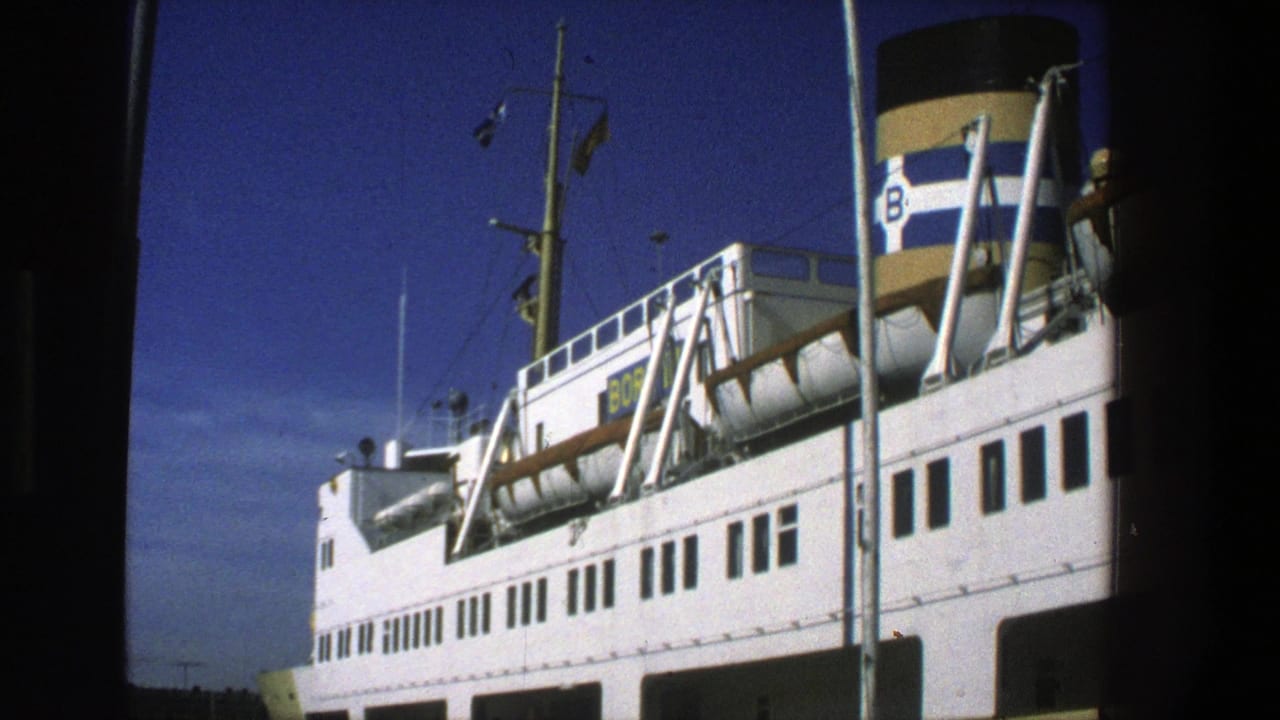White ferry docked at a harbor beneath a deep blue sky.