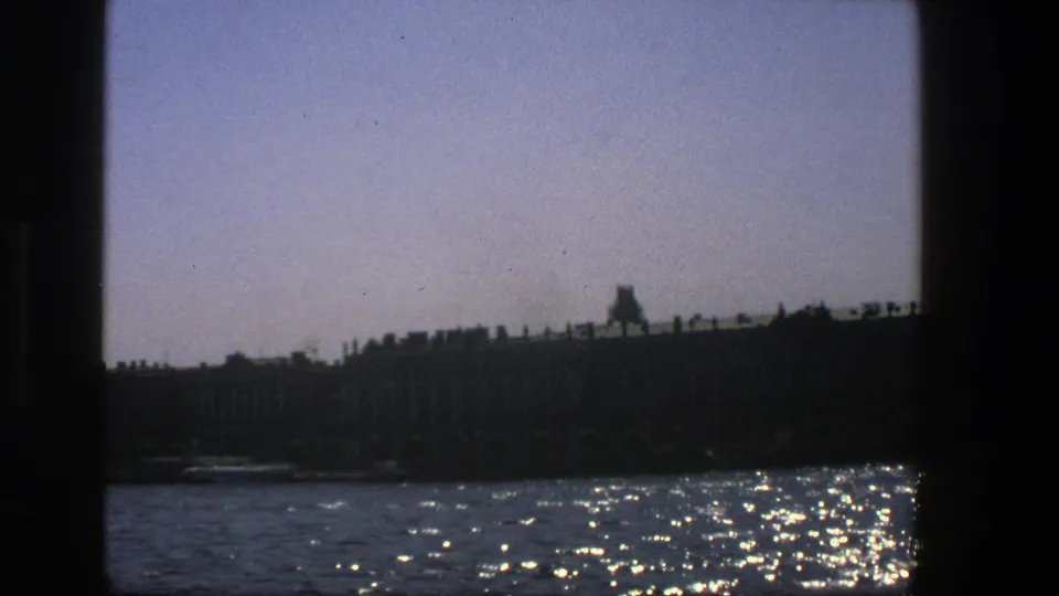 The final 1975 Denmark frame keeps the dark waterfront at the horizon while sunlight scatters across the moving water.