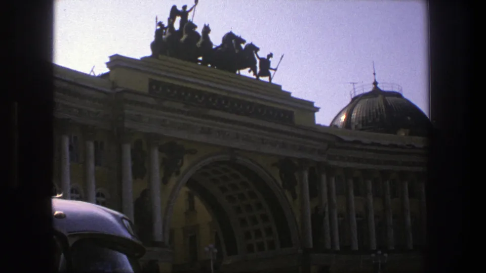 Soft 8mm frame from Denmark in 1975 showing the monumental arched building and dome through a dark interior window edge.