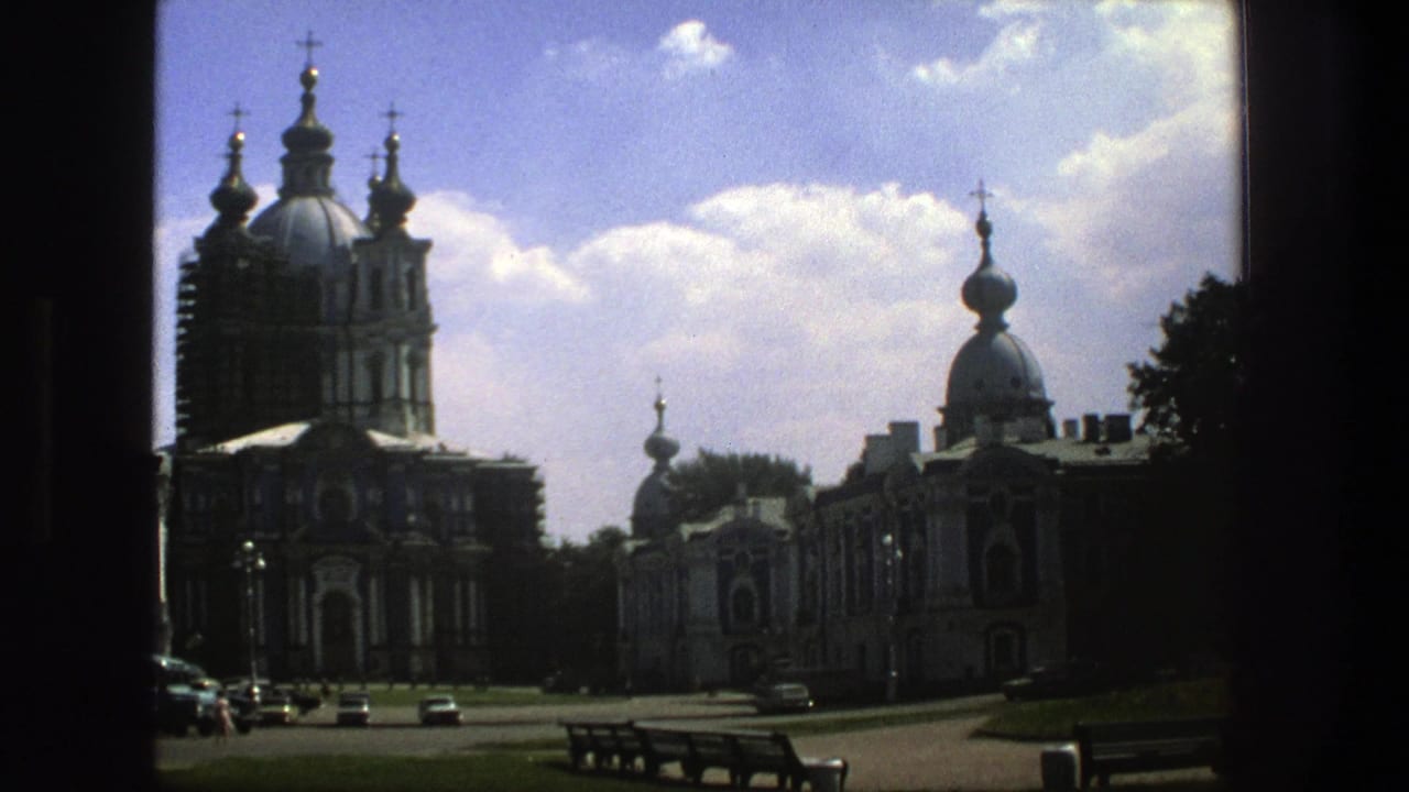 1975 Denmark 8mm frame showing a grand Orthodox-style cathedral exterior with onion domes, crosses, benches, and cars in view.