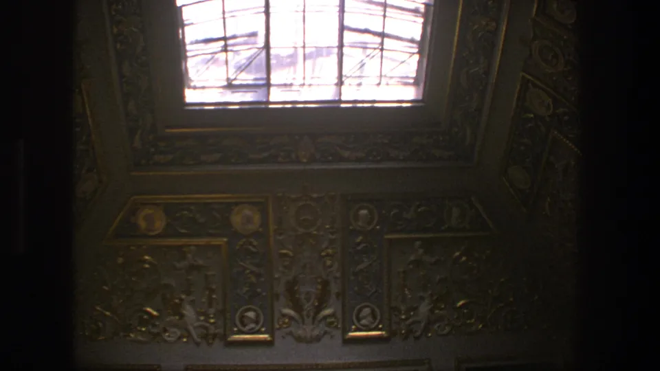 1975 Denmark 8mm interior view looking up at ornate gilded and blue ceiling decoration beneath a bright skylight.
